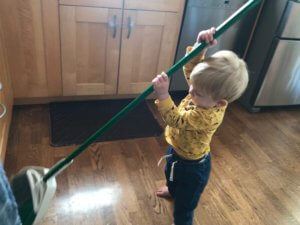 Children don't need us as much as we think they do child sweeping kitchen floor while mom works