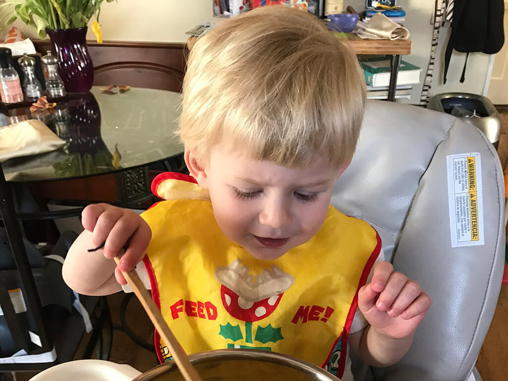 parenting child in high chair while working from home