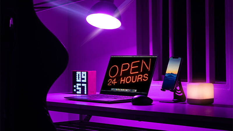 Laptop with the words OPEN 24 HOURS on the display